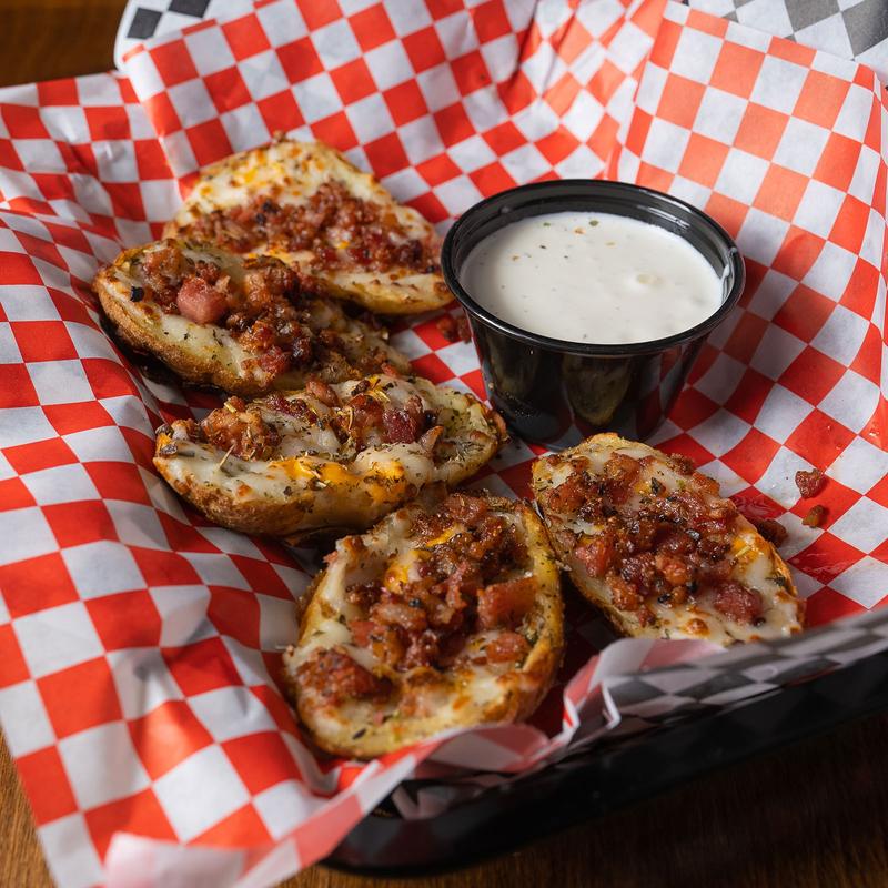 Baked potato skins, with bacon, whiz cheese, mozzarella and ranch dressing