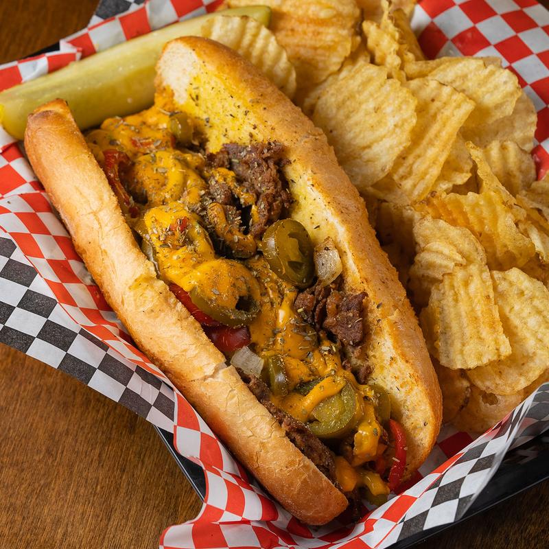 Philly Cheesesteak and potato chips, closeup