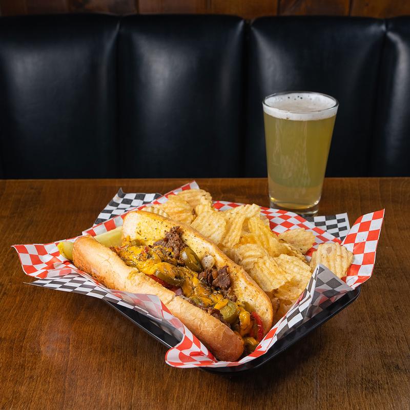 Philly Cheesesteak, with peppers, potato chips and beer