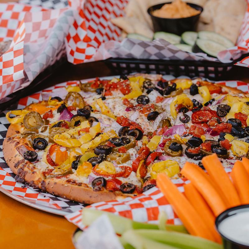 Veggie pizza, with various dishes on the side